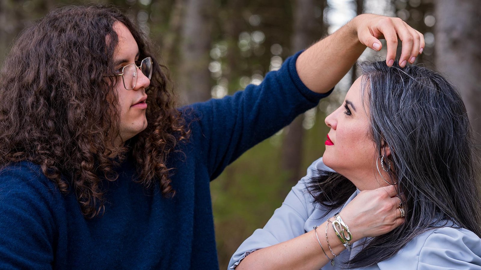 Teen son playfully tousling his mom’s hair during a relaxed family photo session near Ann Arbor
