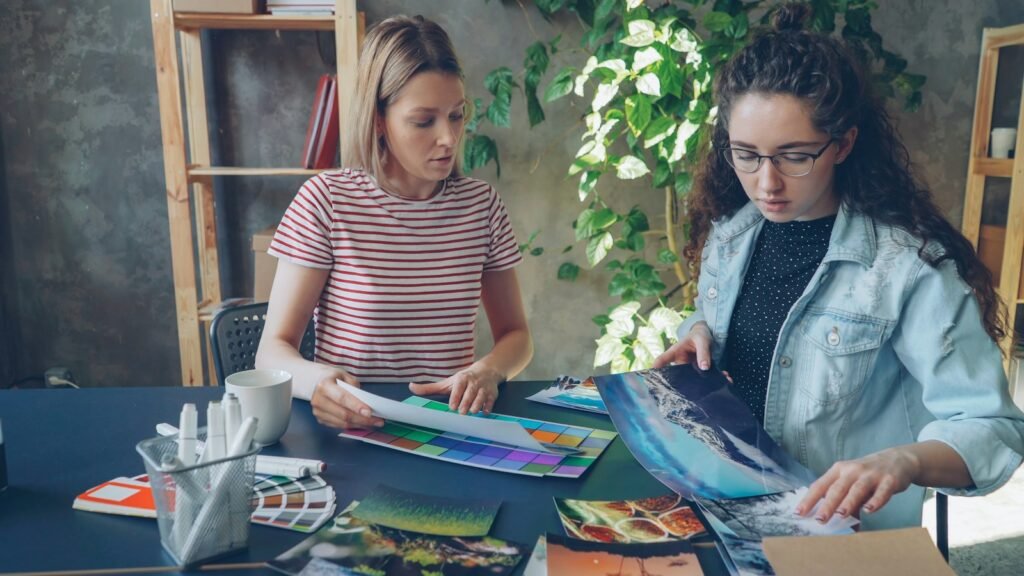 Two women selecting photos together for their vision boards