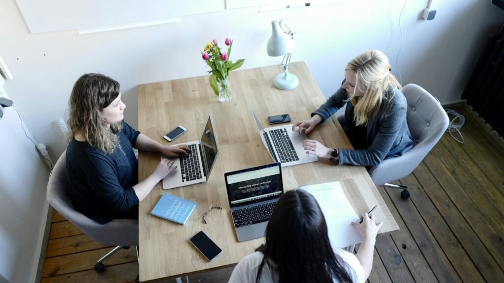 Small group working together at a table during a brand workshop